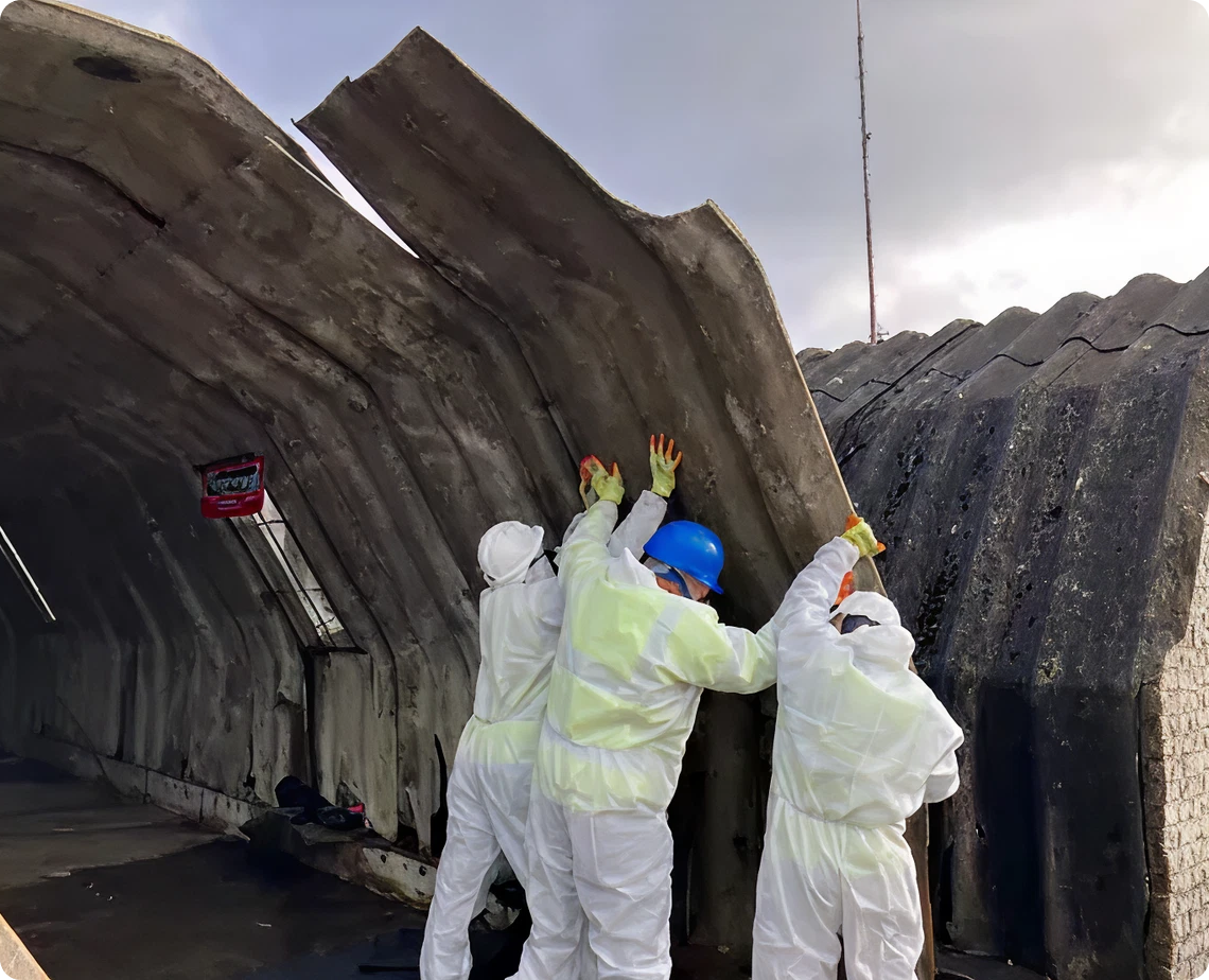 Construction workers inspecting damaged building roof